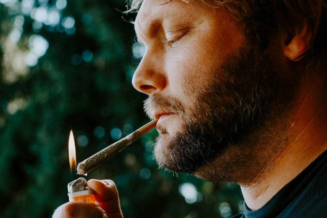 man lighting up a joint
