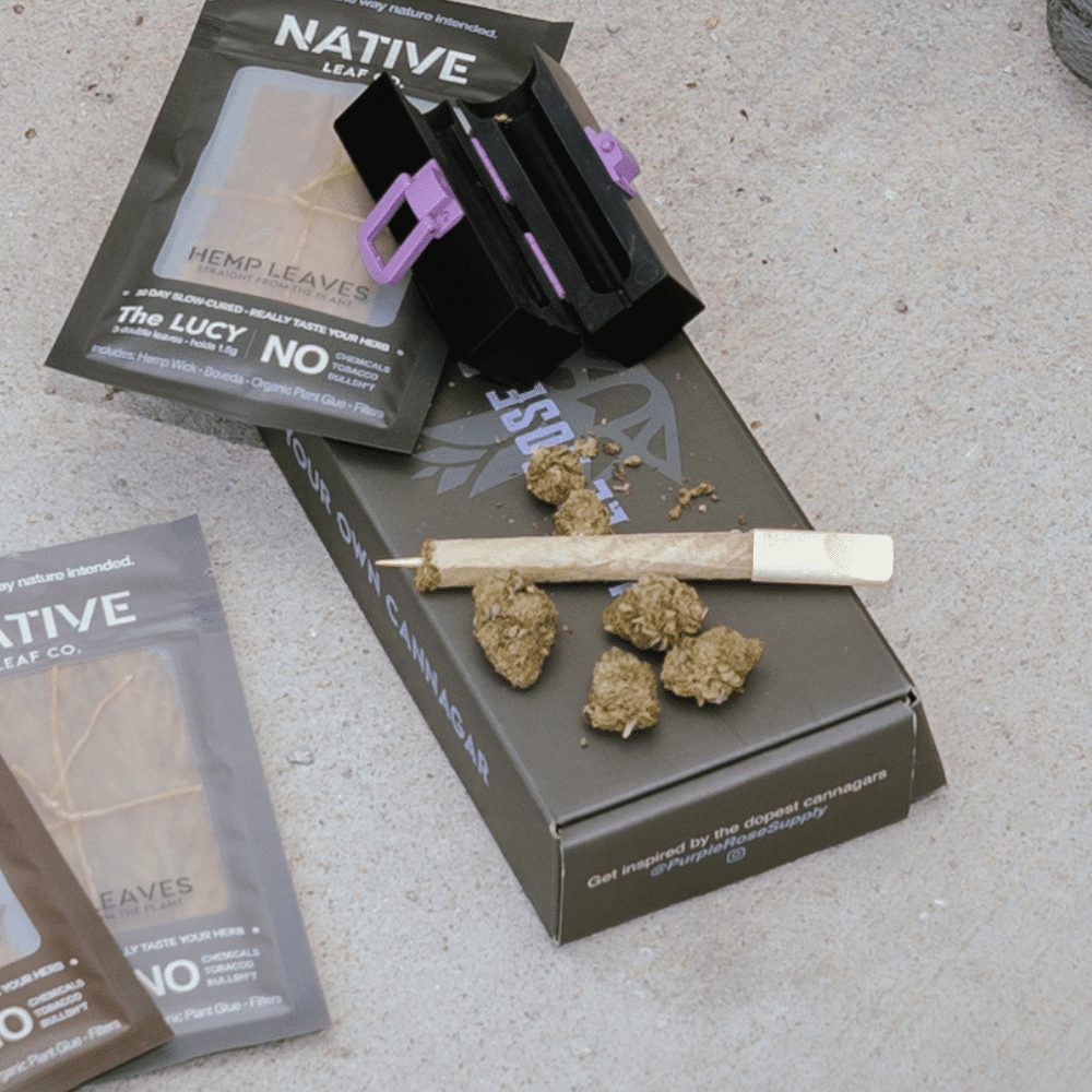 Purple Rose Supply’s Personal cannagar box set displayed with CannaMold, 2-4 grams of weed, weed cigar (cannagar), and shown with Native Co hemp leaf paper packages.