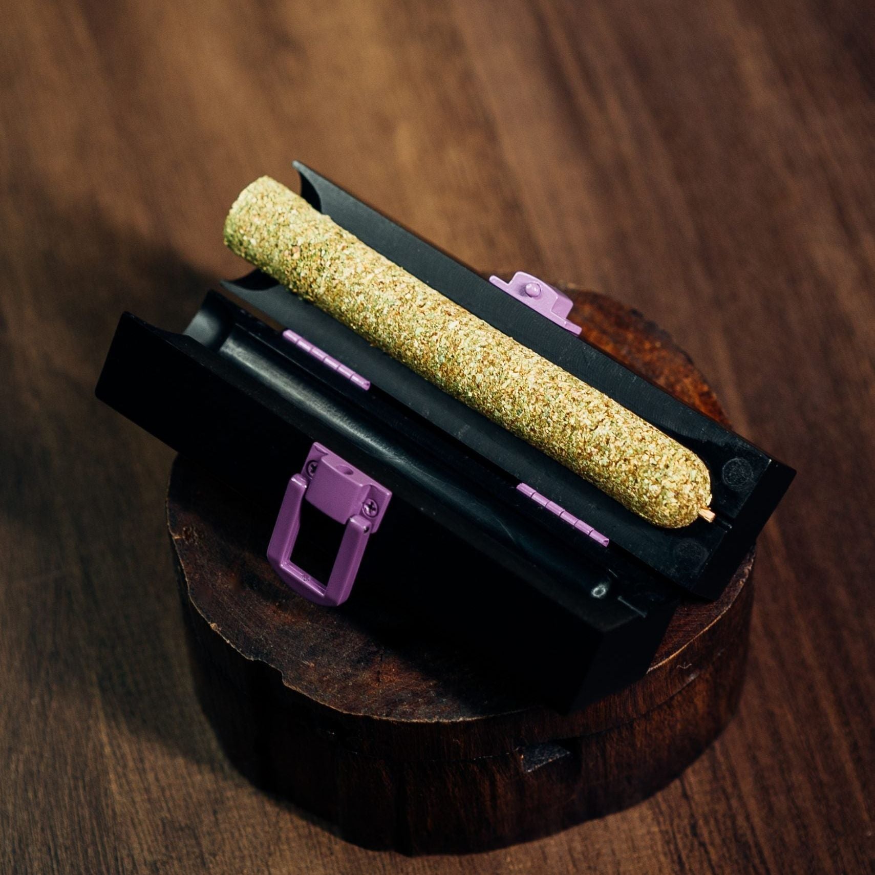 LARGE CannaMold with cannagar from Purple Rose Supply displayed on a wooden pedestal. The cannagar mold is displayed with a freshly pressed cannabis cigar - large enough for a group of people to smoke.